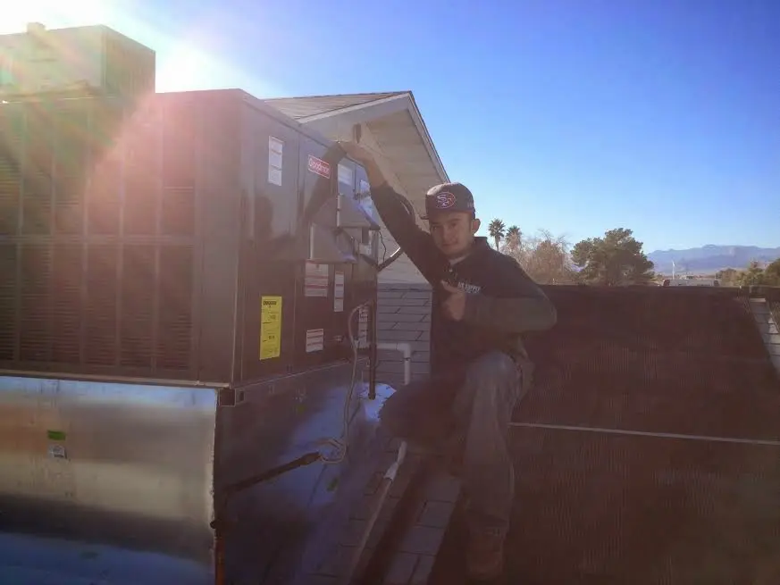 HVAC technician performing HVAC Inspection on a rooftop unit in North Brunswick